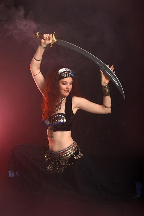 Belly dancer Jade lunging with scimitar